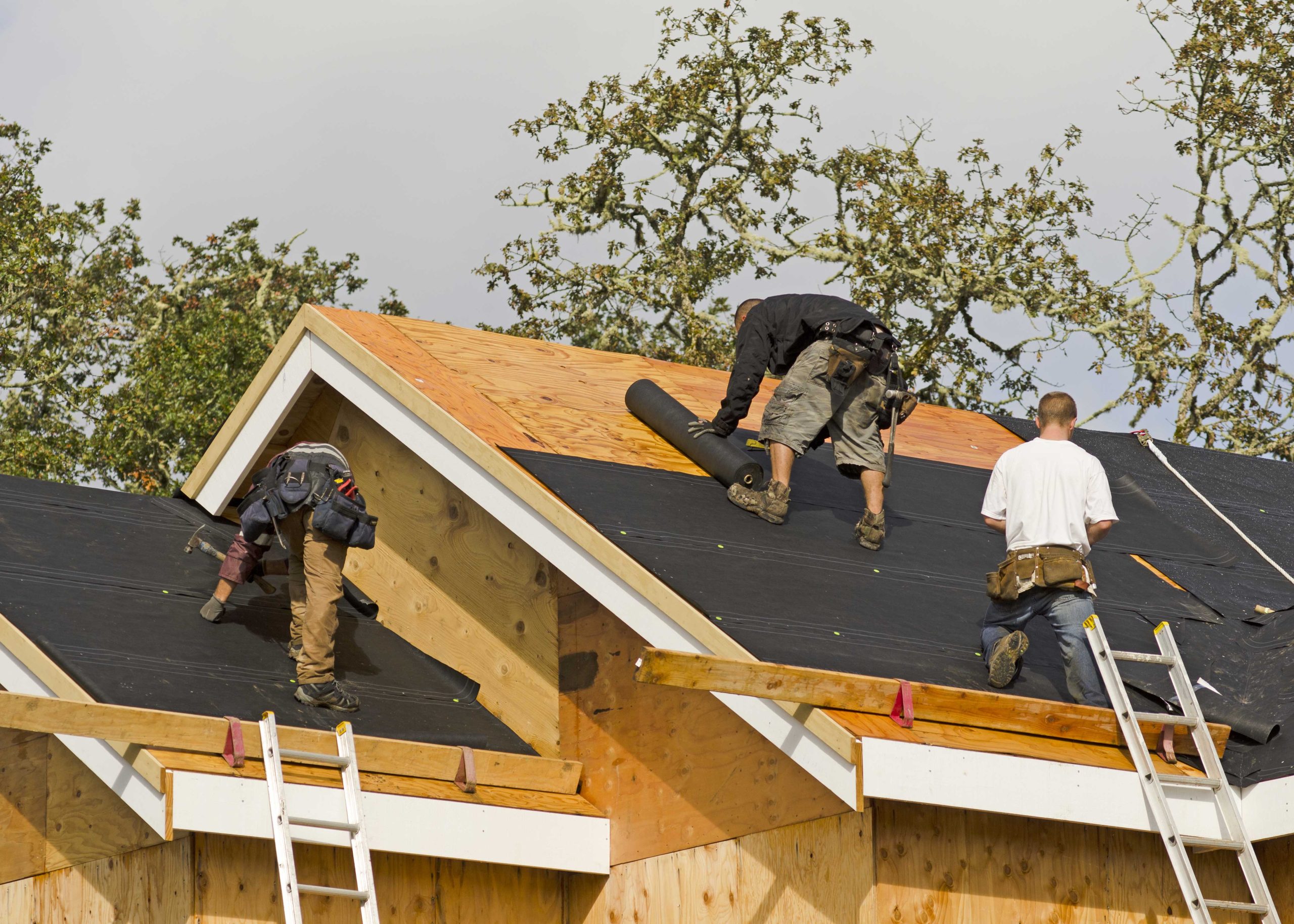 Professional roofers working on a home in Auburn